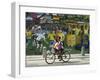 Two Children Ride Their Bicycle Pass a Mural-null-Framed Photographic Print