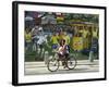 Two Children Ride Their Bicycle Pass a Mural-null-Framed Photographic Print