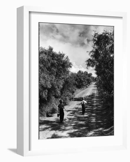 Two Children Walking Down a Dirt Road Going Fishing on a Summer Day-John Dominis-Framed Photographic Print