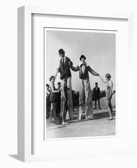 Two Clowns on Stilts Assisted by Girls in Bathing Costumes at Ramsgate Kent England-null-Framed Art Print