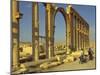 Two Cyclists Pass the Great Colonnade (Cardo), Palmyra, Unesco World Heritage Site, Syria-Eitan Simanor-Mounted Photographic Print