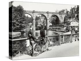 Two Cyclists Take a Break on a Bridge Over the River Nidd at Knaresborough-Fred Musto-Stretched Canvas