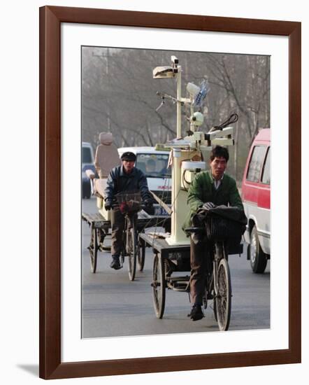 Two Delivery Riders Carry a Dentists Drill and Chair Along a Beijing Street January 4-null-Framed Photographic Print