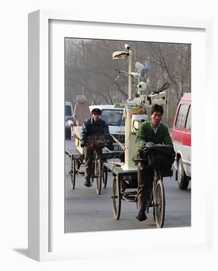 Two Delivery Riders Carry a Dentists Drill and Chair Along a Beijing Street January 4-null-Framed Photographic Print