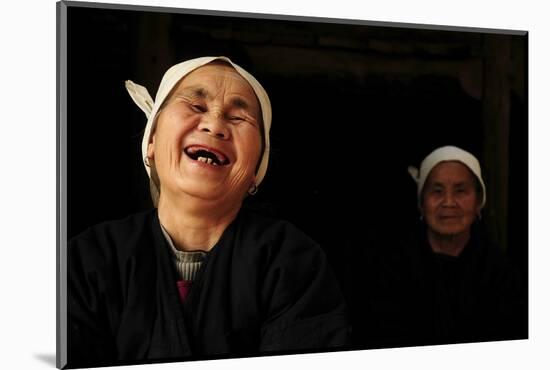 Two Dong Women, One Laughing, in a Dark Room, Sanjiang Dong Village, Guangxi, China-Enrique Lopez-Tapia-Mounted Photographic Print