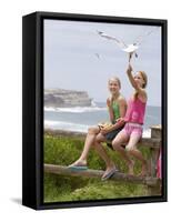 Two Girls Feeding Chips to a Seagull at the Beach-Louise Hammond-Framed Stretched Canvas