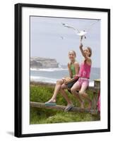 Two Girls Feeding Chips to a Seagull at the Beach-Louise Hammond-Framed Photographic Print