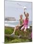 Two Girls Feeding Chips to a Seagull at the Beach-Louise Hammond-Mounted Photographic Print