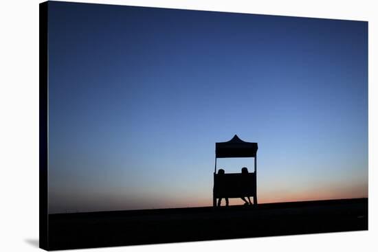 Two Girls Sit on a Bench by a Lake in Yangon at Sunrise-Damir Sagolj-Stretched Canvas