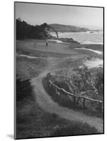 Two Golfers Playing on a Putting Green at Pebble Beach Golf Course-Nina Leen-Mounted Photographic Print