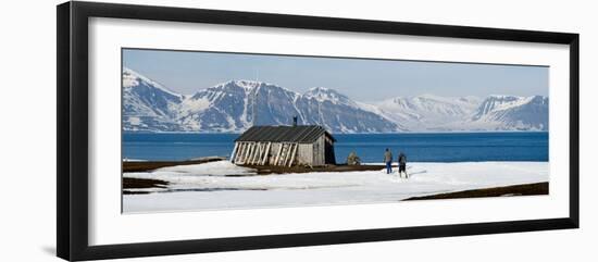 Two Hikers Standing on the Beach Near a Hunting Cabin, Bellsund, Spitsbergen, Svalbard Islands-null-Framed Photographic Print