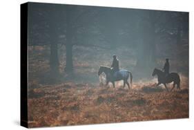 Two Horseback Riders Make their Way Through Misty Richmond Park in Winter-Alex Saberi-Stretched Canvas