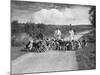 Two Kennel Workers Exercising Foxhounds on an English Country Lane-null-Mounted Photographic Print