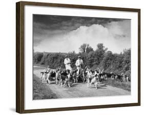 Two Kennel Workers Exercising Foxhounds on an English Country Lane-null-Framed Photographic Print