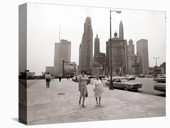 Two Ladies Walking the Sidewalk Skyscrapers in Chicago America's Windy City, in the 1960s-null-Stretched Canvas