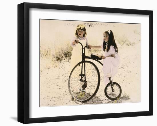 Two Little Girls by an Old Fashioned Bicycle-Nora Hernandez-Framed Giclee Print