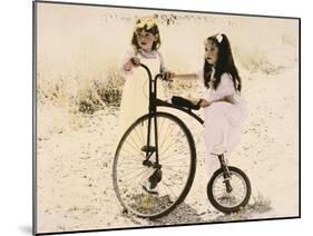 Two Little Girls by an Old Fashioned Bicycle-Nora Hernandez-Mounted Giclee Print