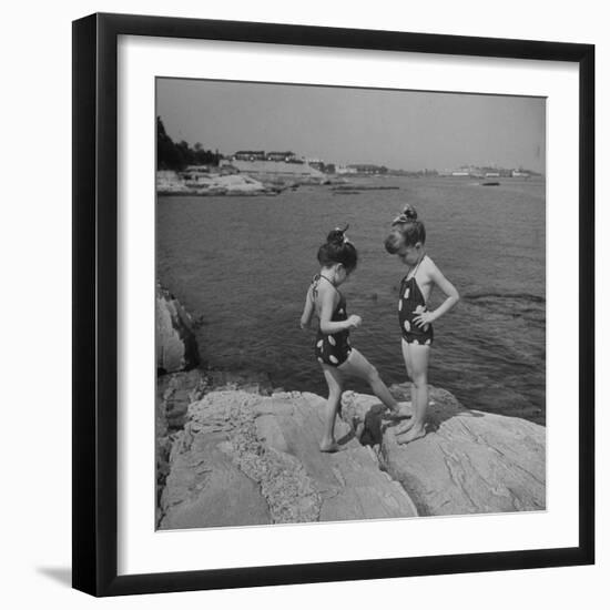 Two Little Girls Modelling Sun Dot Bathing Suits While Playing on the Rocks-Nina Leen-Framed Photographic Print