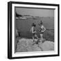 Two Little Girls Modelling Sun Dot Bathing Suits While Playing on the Rocks-Nina Leen-Framed Photographic Print