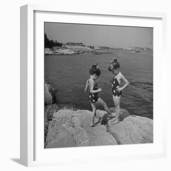 Two Little Girls Modelling Sun Dot Bathing Suits While Playing on the Rocks-Nina Leen-Framed Photographic Print