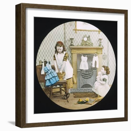 Two Little Girls Wash Their Dolls' Clothes-null-Framed Photographic Print