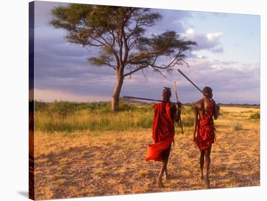 Two Maasai Morans Walking with Spears at Sunset, Amboseli National Park, Kenya-Alison Jones-Stretched Canvas