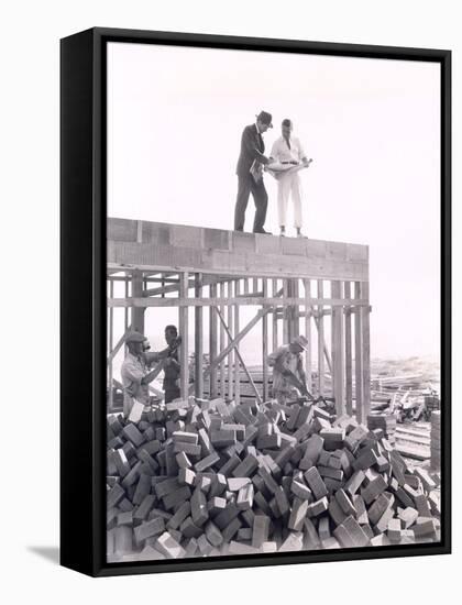 Two Men Going over Blueprints-null-Framed Stretched Canvas