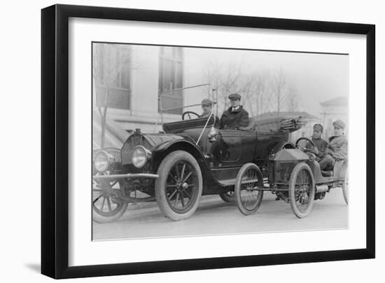 Two Men in a Large Auto are Side by Two Men in a Miniature Auto-null-Framed Art Print