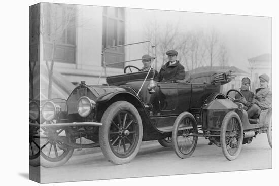 Two Men in a Large Auto are Side by Two Men in a Miniature Auto-null-Stretched Canvas