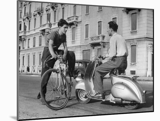 Two Men Talking in Street with Vespa Scooter and Bicycle-Dmitri Kessel-Mounted Photographic Print