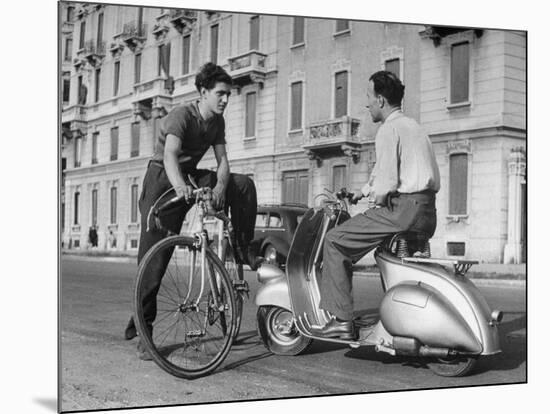 Two Men Talking in Street with Vespa Scooter and Bicycle-Dmitri Kessel-Mounted Photographic Print