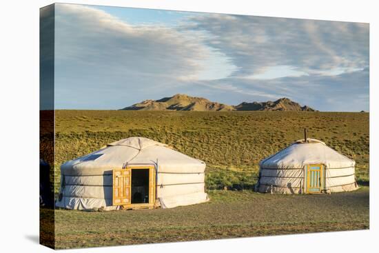 Two Mongolian nomadic gers and mountains in the background, Bayandalai district, South Gobi provinc-Francesco Vaninetti-Stretched Canvas