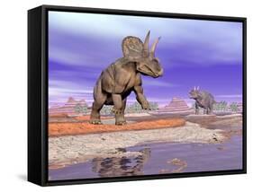 Two Nedoceratops Next to Water in a Colorful Rocky Landscape-null-Framed Stretched Canvas