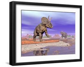 Two Nedoceratops Next to Water in a Colorful Rocky Landscape-null-Framed Art Print