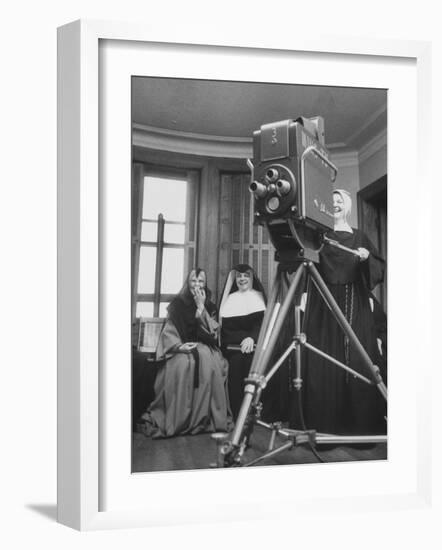 Two Nuns Smiling from the Wings While the Third Is Operating the Large TV Camera-null-Framed Photographic Print