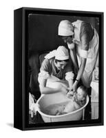 Two Nurses Bath a Baby-null-Framed Stretched Canvas
