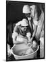 Two Nurses Bath a Baby-null-Mounted Art Print