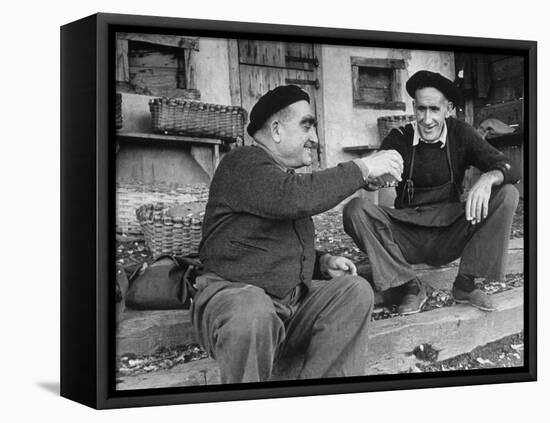 Two Older Basque Men Sitting on a Porch Toasting, as They Prepare to Drink Together-Dmitri Kessel-Framed Stretched Canvas