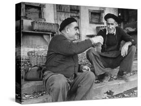 Two Older Basque Men Sitting on a Porch Toasting, as They Prepare to Drink Together-Dmitri Kessel-Stretched Canvas