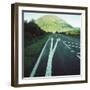 Two painted arrows on a road pointing towards a grassy mountain-null-Framed Photographic Print