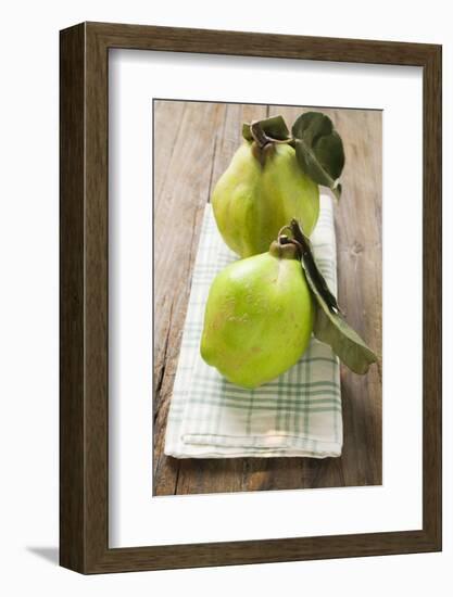 Two Quinces with Leaves on Tea Towel-Eising Studio - Food Photo and Video-Framed Photographic Print