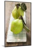 Two Quinces with Leaves on Tea Towel-Eising Studio - Food Photo and Video-Mounted Photographic Print