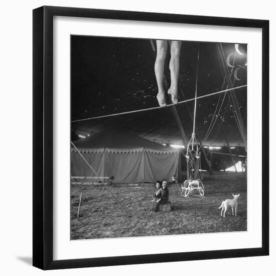 Two Small Children Watching Circus Performer Practicing on Tightrope, Her Legs Only Visible-Nina Leen-Framed Premium Photographic Print