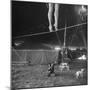 Two Small Children Watching Circus Performer Practicing on Tightrope, Her Legs Only Visible-Nina Leen-Mounted Photographic Print