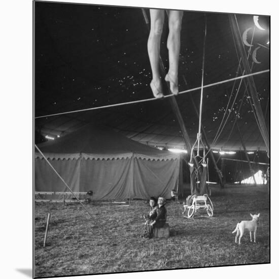 Two Small Children Watching Circus Performer Practicing on Tightrope, Her Legs Only Visible-Nina Leen-Mounted Photographic Print