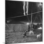 Two Small Children Watching Circus Performer Practicing on Tightrope, Her Legs Only Visible-Nina Leen-Mounted Photographic Print