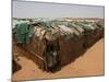 Two Sudanese Boys Stand by Makeshift Huts-null-Mounted Photographic Print