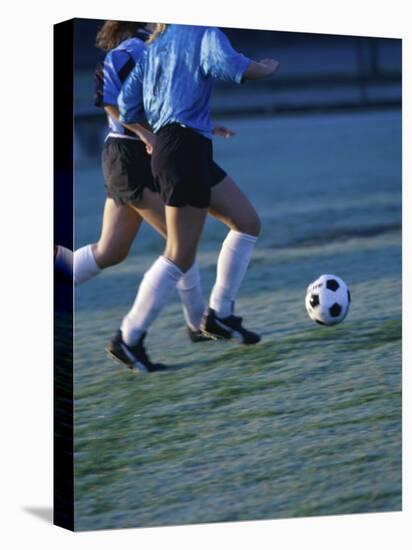 Two Teenage Girls Running for a Soccer Ball-null-Stretched Canvas