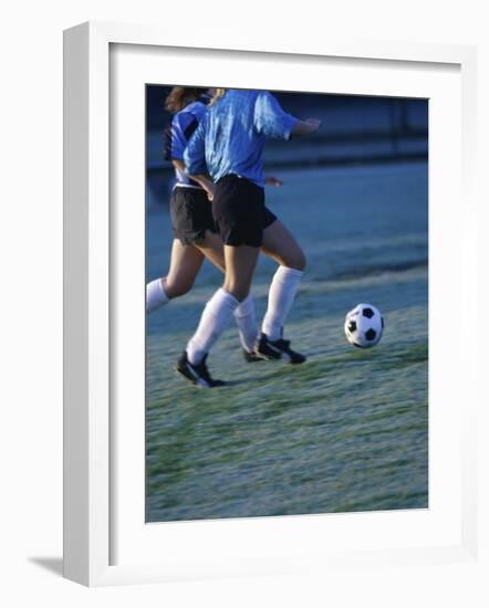 Two Teenage Girls Running for a Soccer Ball-null-Framed Photographic Print