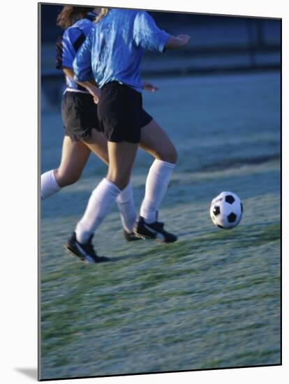 Two Teenage Girls Running for a Soccer Ball-null-Mounted Photographic Print